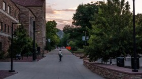 A person walks through the campus of the University of Colorado Boulder, Tuesday, July 14, 2026, in Boulder. (