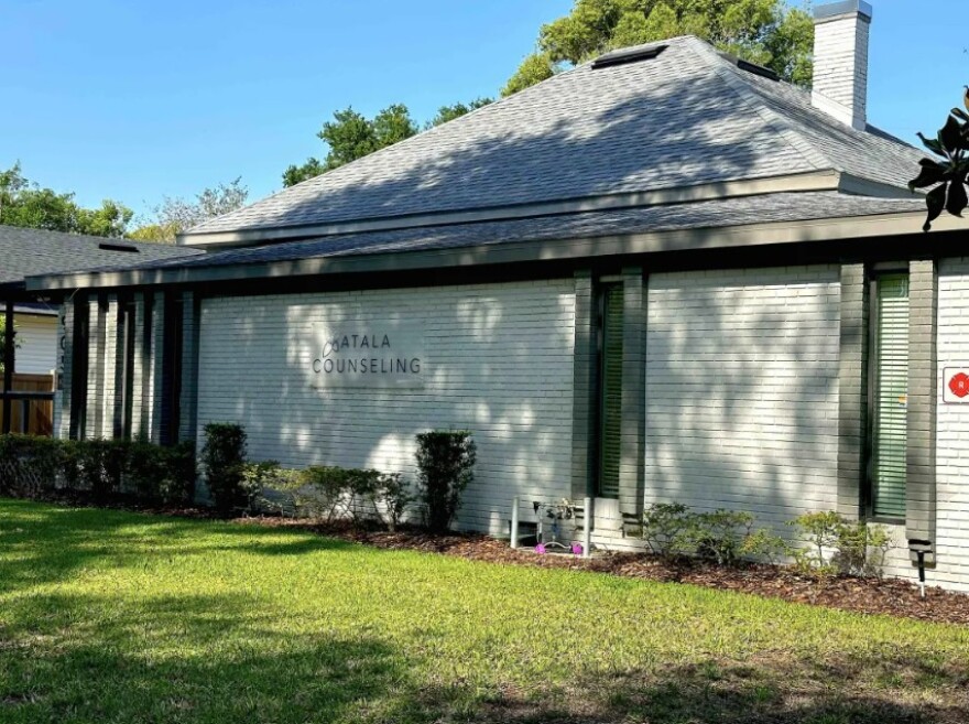 White brick building says Atala Counseling with grass in the foreground
