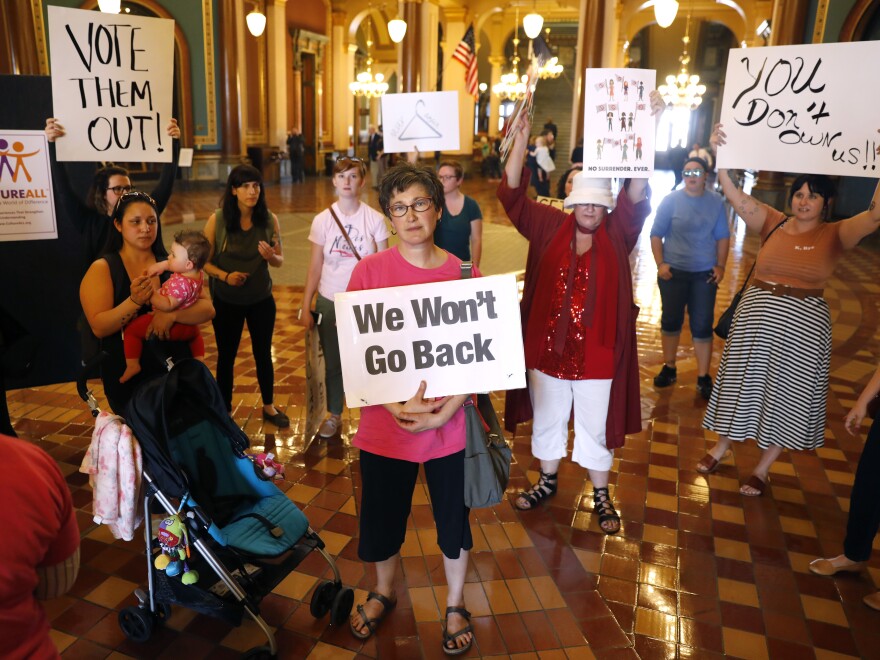 Protesters rally outside Reynolds' office on Friday.