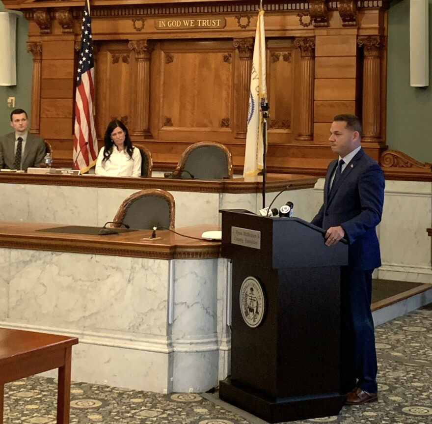 County Executive Ryan McMahon delivers his budget address to the legislature as Chairwoman Watts looks on.