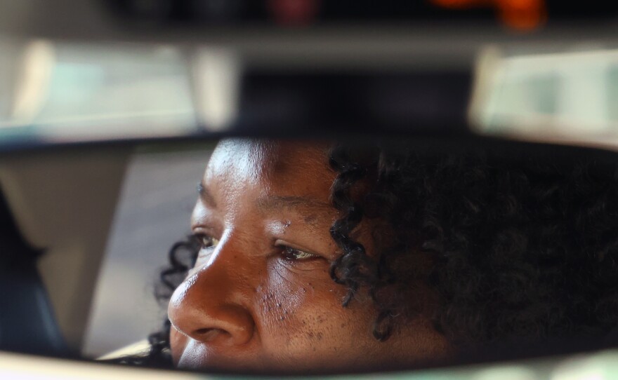 Jaquelyn “Jackie” King, a rideshare driver for the company Uber, waits for rider Jimmy Rochelle in Gainesville, Fla., on Thursday, Nov. 20, 2025. Rochelle was using the rideshare service to get home from the UF Shands Hospital.