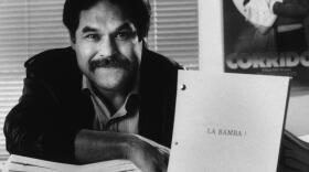 Luis Valdez, who 20 years ago began a Chicano theater company that performed on a truck for farm workers, is emerging as an innovative playwright for a broad audience, and is picture in his office in Los Angeles, March 13, 1986. The author of "Zoot Suit" poses with a copy of his new screenplay "La Bamba!" based on the life of rock musician Ritchie Valens. (Mark Terrill/AP)