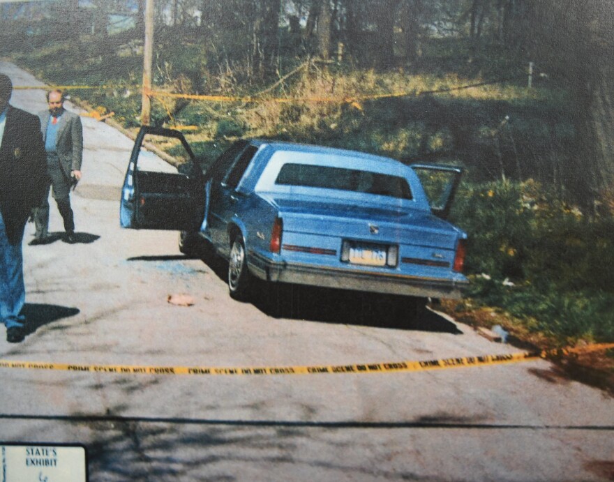 Crime scene photo of the vehicle where two men were shot and killed on Hutchings Street in Kansas City, Kansas, on April 15, 1994. The image is from the McIntyre case file. 