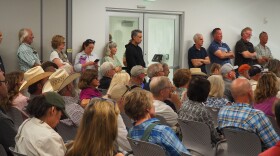 Summit County residents stand at an Aug. 6, 2026, Eastern Summit County Planning Commission hearing to see the slideshow presentation regarding Ivory Homes' potential development in Browns Canyon.