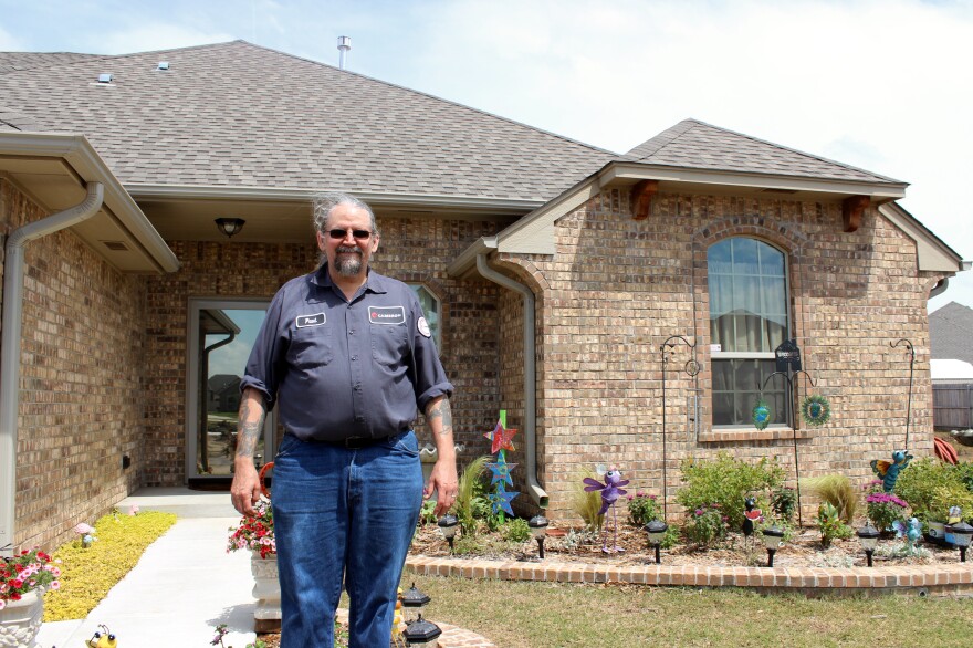 Paul Phillips stands in front of his home. He rebuilt on his lot after the 2013 tornado destroyed his house.