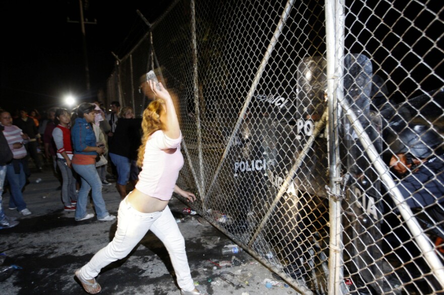 In northern Mexico, relatives of inmates at Apodaca prison outside Monterrey attack the security fence, Feb. 21. Violence at the prison on Feb. 19 left 48 inmates dead; the transfer of three prisoners to another criminal center prompted more violence two days later.