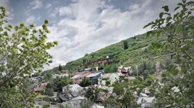 A rendering of the proposed home sitting above the Treasure Hill skyline. The view projected is from the perspective of city hall. The proposed home is four and a half stories, with two levels considered basements because they’re below grade.