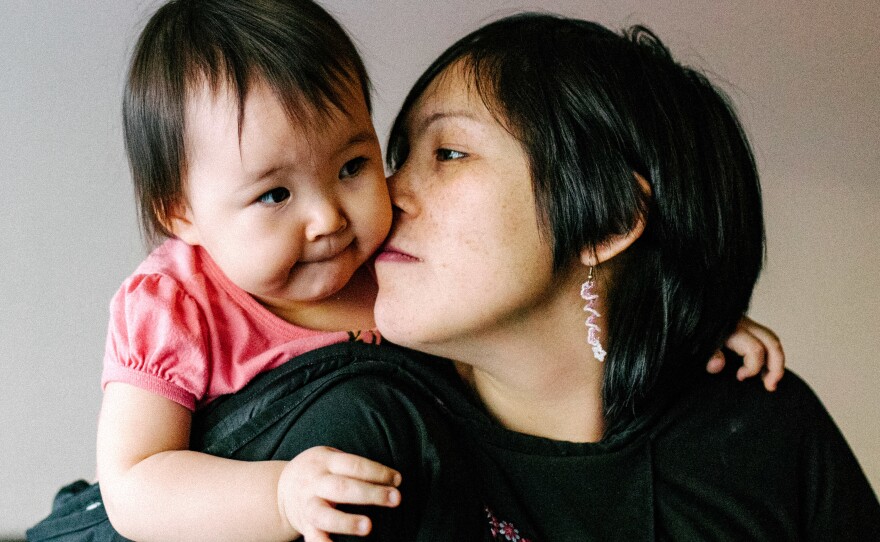 Inuit parenting is gentle and tender. They even have a special kiss for kids called <em>kunik</em>. (Above) Maata Jaw gives her daughter the nose-to-cheek Inuit sniff.