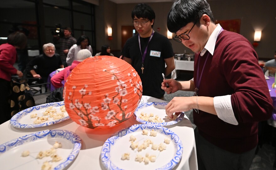 Kazumasa Fujita tallies popcorn pieces after the chopstick challenge.