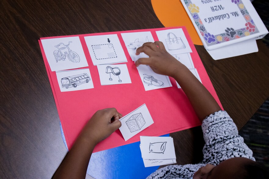  A second grade student at John Burroughs Elementary school matches the beginning sounds of words represented by pictures.