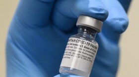 Army Spc. Angel Laureano holds a vial of the COVID-19 vaccine, Walter Reed National Military Medical Center, Bethesda, Md., Dec. 14, 2020. (DoD photo by Lisa Ferdinando)