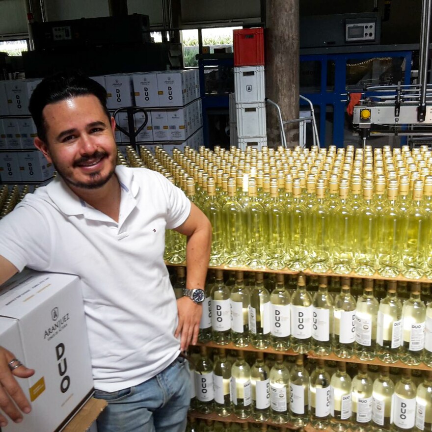 Gerardo Aguirre, export manager for the Aranjuez winery in Tarija, Bolivia, surrounded by bottles of the company's wines.