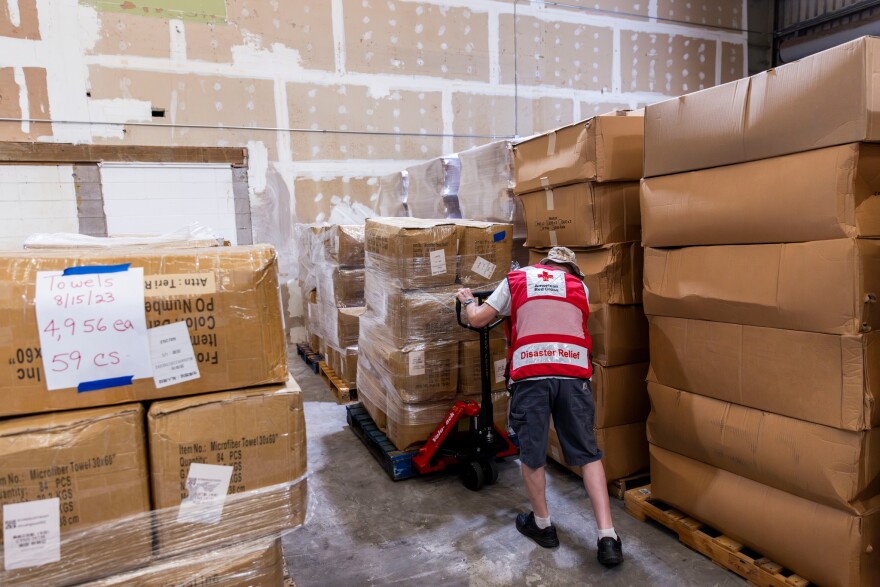 American Red Cross volunteer Terry Buchen uses a pallet jack to organize supplies and materials at the Red Cross warehouse in Wailuku, Hawaiʻi, on the island of Maui.