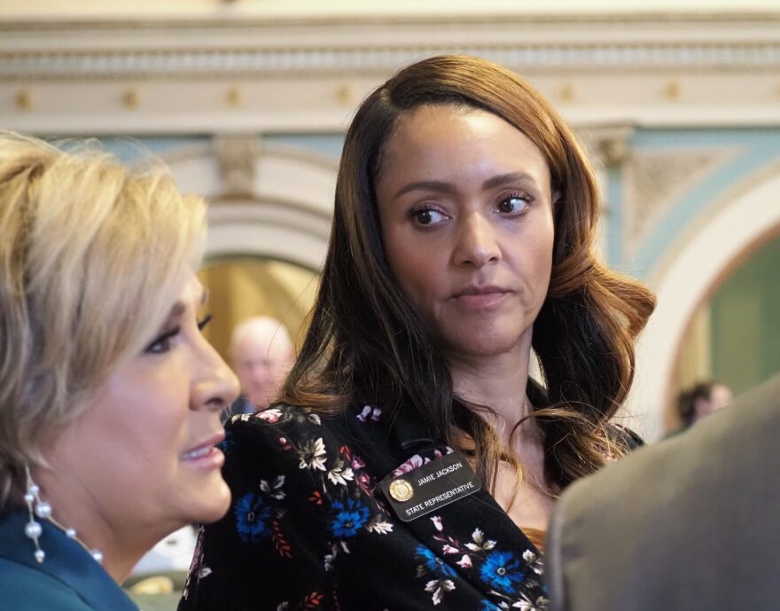 Colorado state Rep. Jamie Jackson listens to Majority Leader Monica Duran on the House floor.