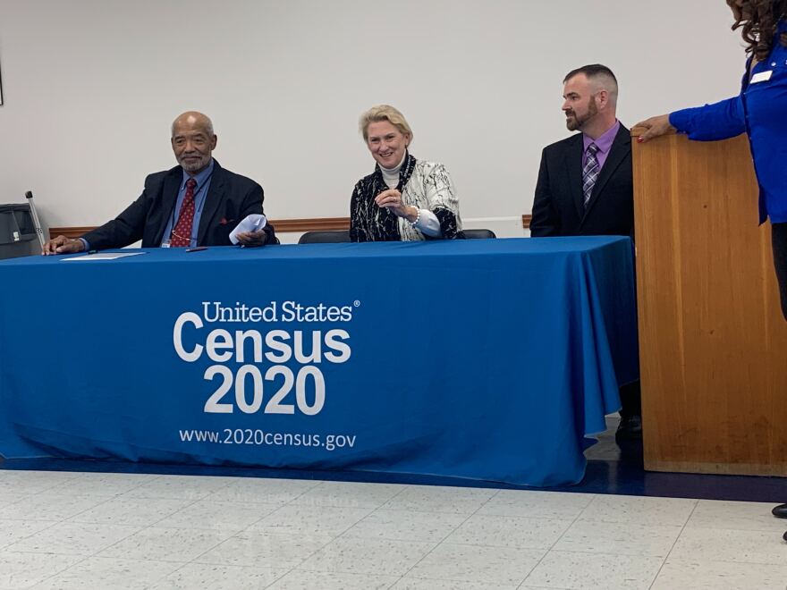 Census officials seated at table