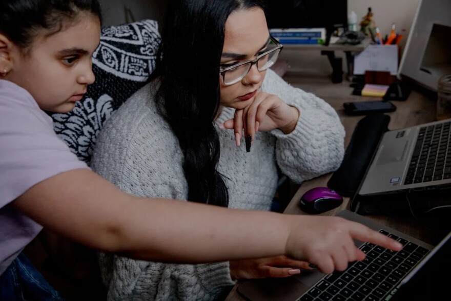 Kennedy’s daughter, Jade Atallah, 9, looks at her policy research. “Is the benefit of me staying here feasible for me and my family, considering that I have this professional degree, that I will be licensed, that I can hold leadership positions, and I can be an executive director,” she said. “But does Connecticut value that?”