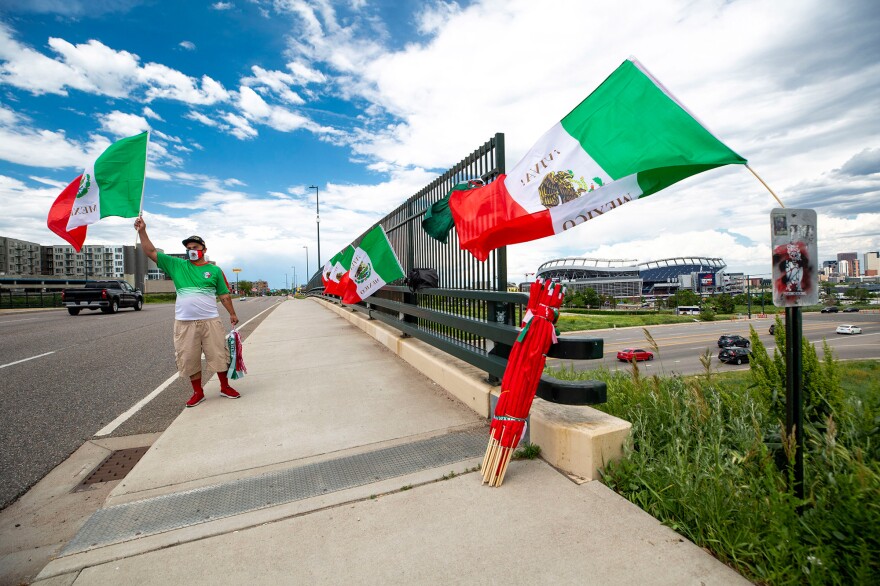 Raul Gomez sells Mexican flags Tuesday before the U.S. and Mexico national teams face off in the CONCACAF Nations League finals at Mile High Stadium.