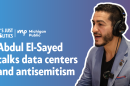 On the left side of the image are the It's Just Politics and Michigan Public logos. Underneath them are the words "Abdul El-Sayed talks data centers and antisemitism." To the right is an outlined photo of Abdul El-Sayed in a jacket and black shirt wearing headphones. Behind all of this is a blue and purple gradient background.