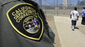 Inmates pass a correctional officer as they leave an exercise yard. (Rich Pedroncelli/AP)