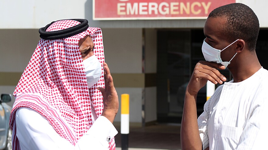 Men outside a hospital in Dammam, Saudi Arabia, wear surgical masks as a precaution against infection with a coronavirus.