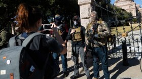 A small group of armed protesters rally outside of the Texas state Capitol grounds. Protesters separated themselves from individuals who took part in the recent attack at the U.S. Capitol, saying their demonstration was scheduled months before. 