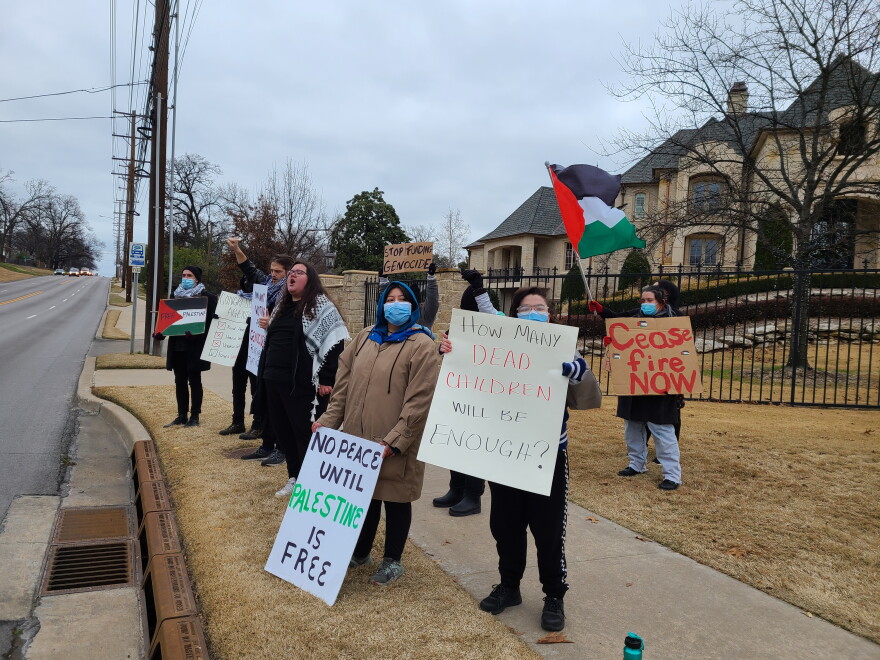 A group of protesters from Oklahomans Against Occupation protest along Lewis Avenue in Tulsa on Dec. 28, 2023.