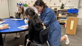 A teacher works with a student at Valencia Newcomer School in Phoenix on April 27, 2023.
