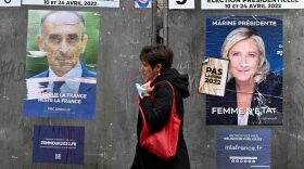 A pedestrian walks past campaign posters of French presidential candidates Eric Zemmour and Marine Le Pen, three days ahed of the first round of the election, in Paris.