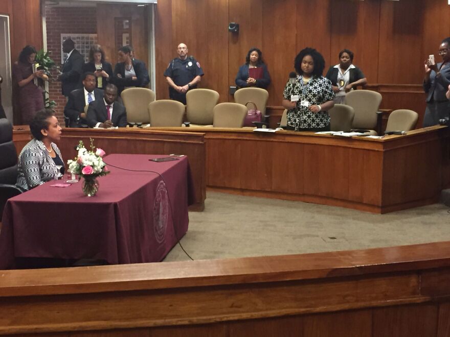 An image of youth radio reporter asking Loretta Lynch a questions during a press conference