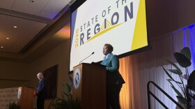 Two presenters stand on stage at a University of South Florida ballroom during the 2026 State of the Region event. 