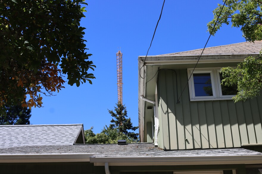 A crane working on the first phase of the Next Generation Housing Development Plan looms over a home in the Villard neighborhood on July 8, 2026.