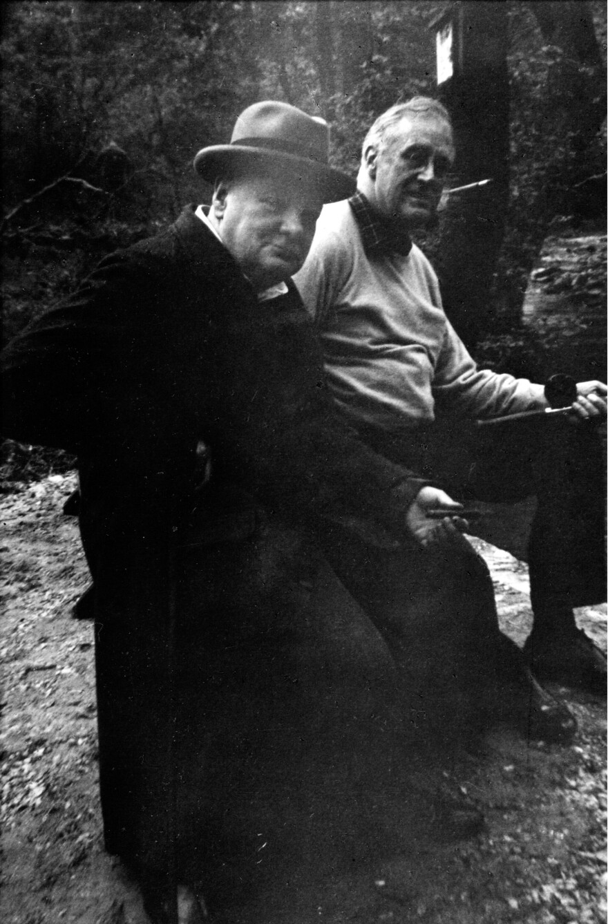 British Prime Minister Winston Churchill and President Franklin D. Roosevelt fishing in a stream at Camp David in May 1943. The presidential retreat was known as "Shangri-La" at the time.