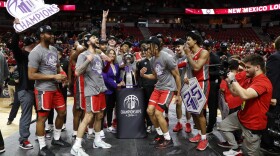 New Mexico players celebrate after defeating San Diego State in an an NCAA college basketball championship game at the Mountain West Conference tournament Saturday, March 16, 2024, in Las Vegas. Mountain West Commissioner Gloria Nevarez, center left, prepares to present the trophy at center. (AP Photo/Steve Marcus)