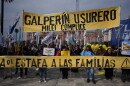 Demonstrators hold a banner with a message that reads in Spanish: "Galperin loan shark, Milei an accomplice" outside the Economy Ministry to demand government action over a household debt crisis in Buenos Aires, Argentina, Thursday, Aug. 20, 2026.