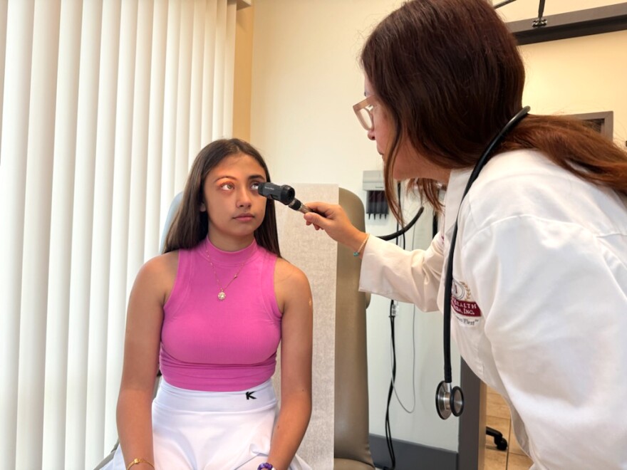 Nurse Practitioner Claudia Belgrano, right, checks a student who came in for a back-to-school event at the Community Health of South Florida, Inc. or CHI West Kendall Health Center on Saturday, Aug. 3, 2024. Florida public schools require certain immunizations and physical exams .