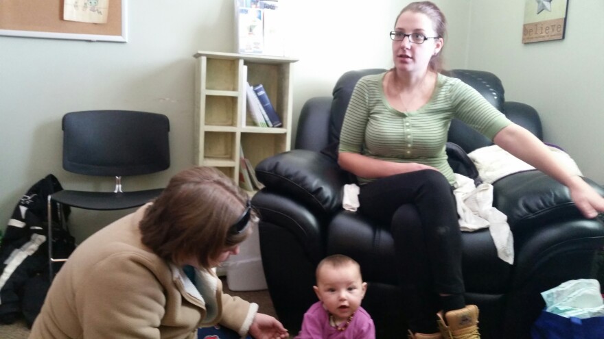 Beth on floor with Danielle's baby at North Bridgton Family Practice