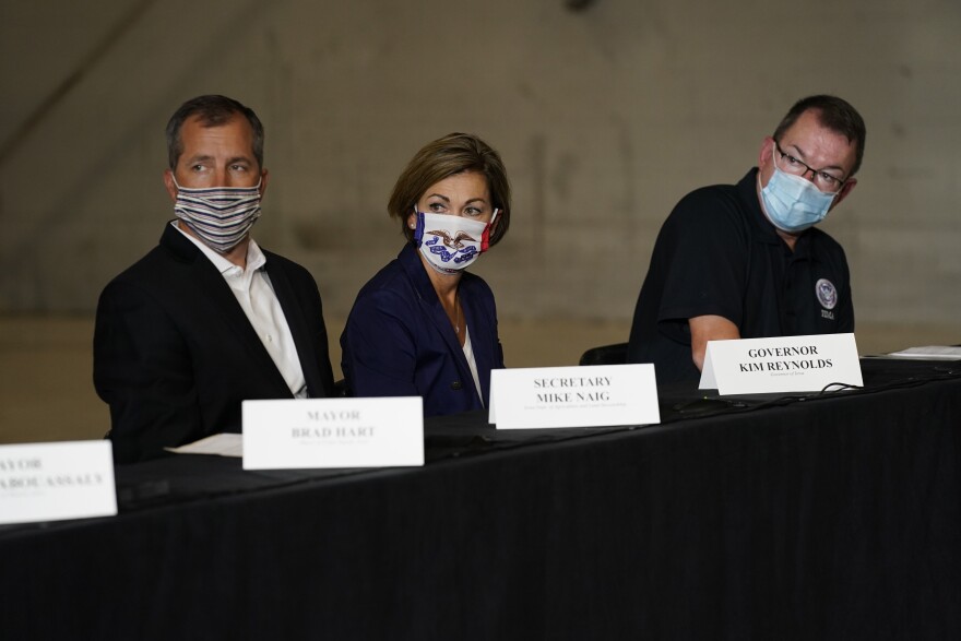 From left, Iowa Secretary of Agriculture Mike Naig, Iowa Gov. Kim Reynolds and Federal Emergency Management Agency Administrator Peter Gaynor listen during a briefing Tuesday on derecho damage and recovery efforts in Iowa.