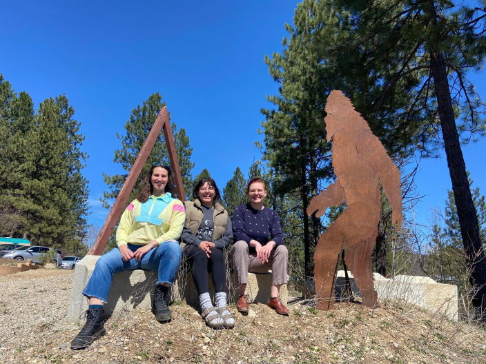 Beth Norton, Kat Lizarraga, and Hailee Lenhart-Wees pose for a picture next to big foot.