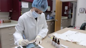 A forensic science examiner performs an analysis at the Connecticut Forensic Science Laboratory. Some state labs face yearslong backlogs across a range of cases, including those requiring DNA and ballistics analysis — delays that, in some communities, are stalling court proceedings and leaving victims waiting for answers. (Photo courtesy of the Connecticut Division of Scientific Services)