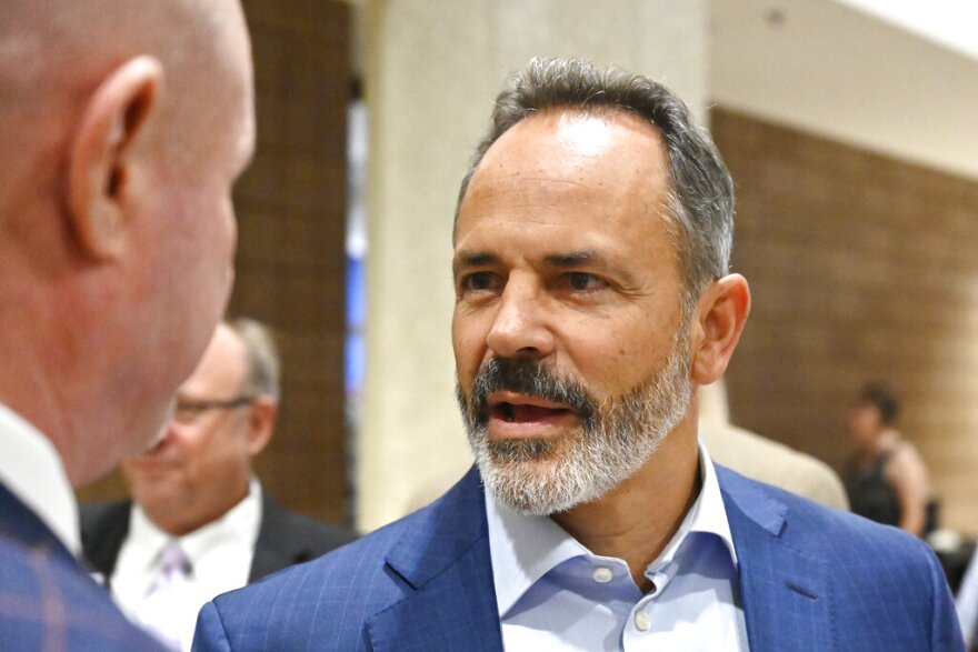 Former Kentucky Governor Matt Bevin, right, speaks with an attendee of the Kentucky Farm Bureau Ham Breakfast at the Kentucky State Fair in Louisville, Ky., Thursday, Aug. 25, 2022. (AP Photo/Timothy D. Easley)