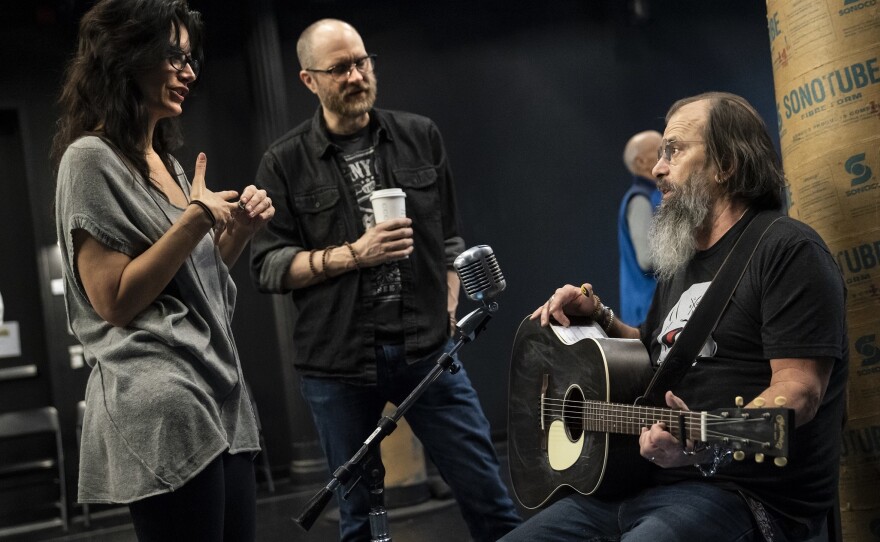 Playwrights Jessica Blank and Erik Jensen talk with Steve Earle during rehearsals.