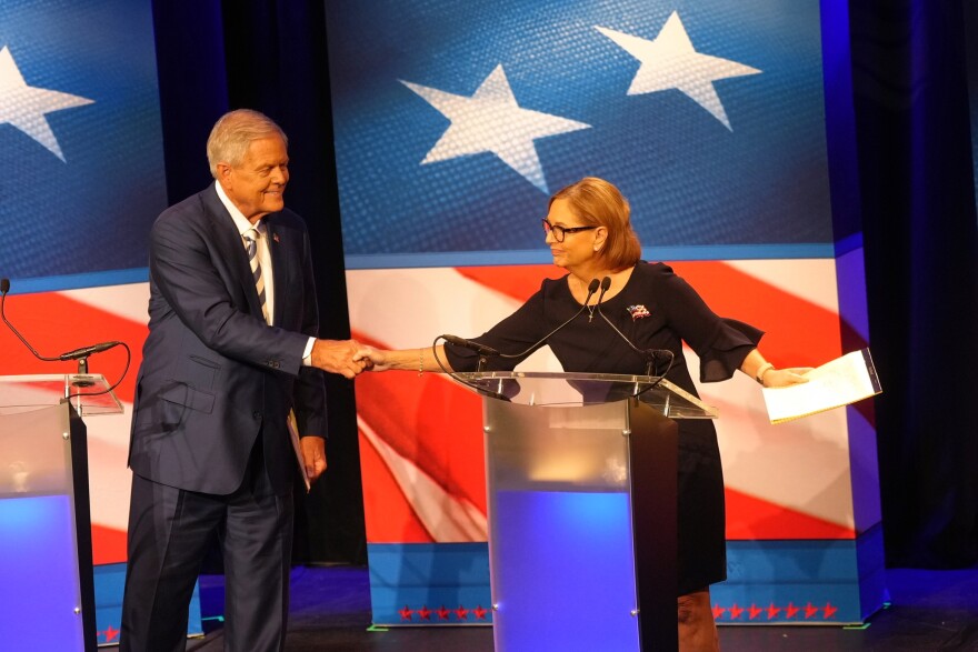 U.S. Rep. Ralph Norman, R-S.C., left, reaches over to shake hands with Sen. Darline Graham, R-S.C., during a debate ahead of the special GOP Senate runoff election to replace the late Sen. Lindsey Graham, R-S.C., in Newberry, S.C., Tuesday, Aug. 18, 2026. (AP Photo/Meg Kinnard)
