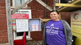 Sara Bowen-Lasisi shows the Narcan boxes kept behind the Phoenix Center's parking lot in Springfield.