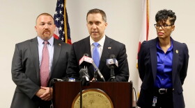 Palm Beach County State Attorney Dave Aronberg speaks during a news conference as chief assistants Brian Fernandes and Adrienne Ellis listen in West Palm Beach, Fla., Wednesday, June 1, 2016. Fired officer Nouman Raja was arrested and charged with attempted murder and manslaughter in the Oct. 18, 2015, death of Corey Jones, 31, after a grand jury found the shooting was unjustified, Aronberg said at the news conference. (Allen Eyestone/Palm Beach Post via AP)