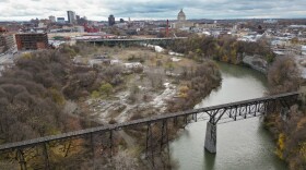 The old RG&E gas plant and Baush + Lomb sites alog the Genesee River in Rochester south of the Running Track Bridge .