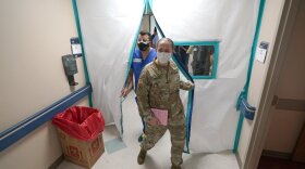 Urban Augmentation Medical Task Force members Army Maj. Katie Bessler, right, and Infectious Disease Physician Maj. Gadiel Alvarado enter a wing at United Memorial Medical Center on Thursday in Houston.