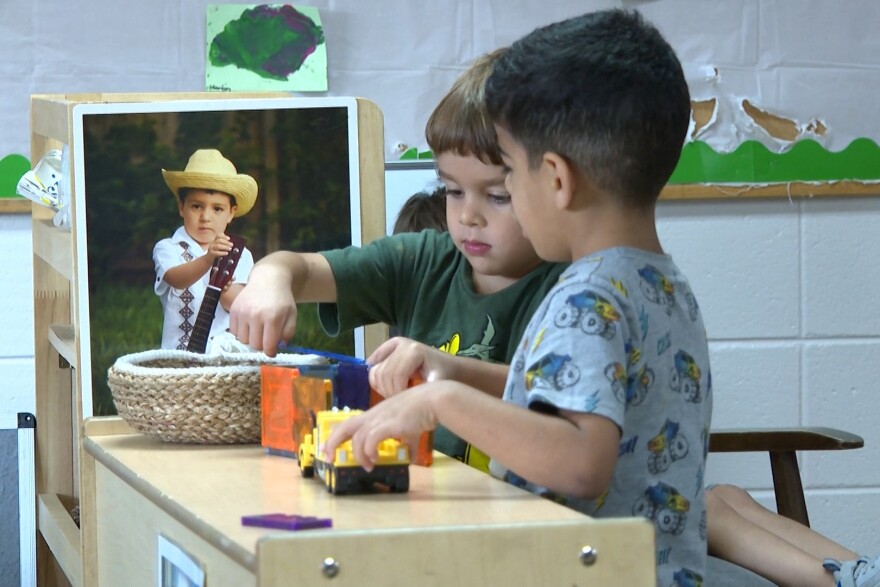 Kids play with trains together at the Compass Early Learning Center in Bloomington