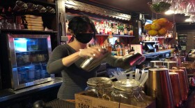 A bartender mixes a drink at Albany's Savoy Taproom. Due to rising COVID-19 rates, the restaurant has curtailed indoor dining for now, but is offering takeout and delivery.