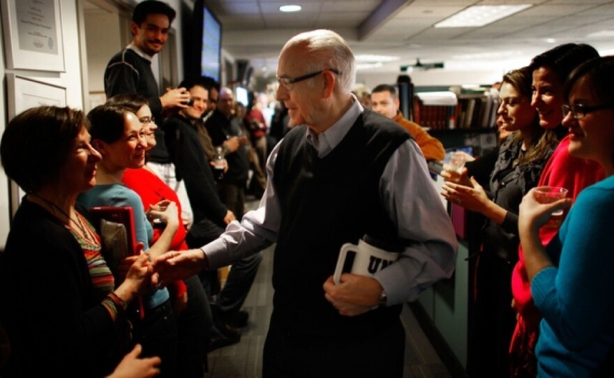 NPR employees line the hallway of the <em>Morning Edition</em> newsroom to cheer for Kasell. He was feted with speeches, champagne and cake following his final 11 a.m. newscast.