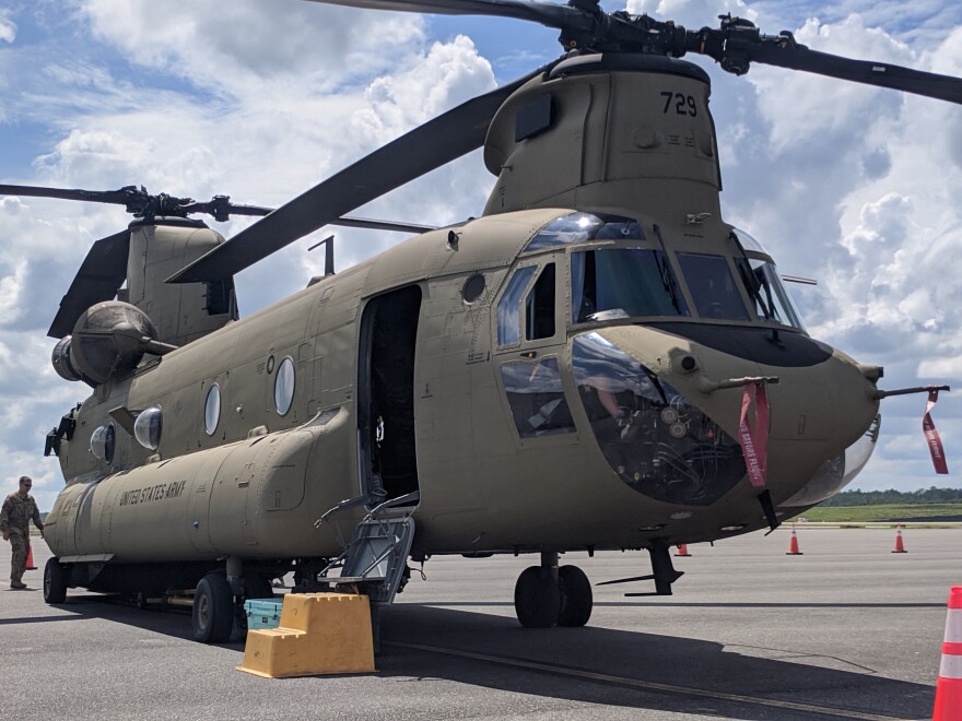 A large helicopter sits on a runway.